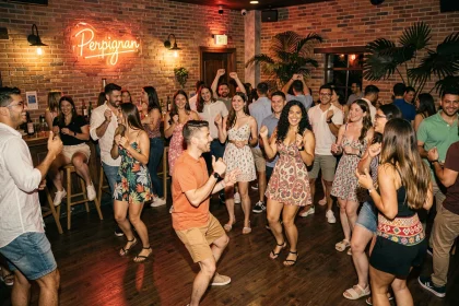 Groupe de jeunes adultes dansant la salsa sur la piste d'une boîte de nuit latino à Perpignan